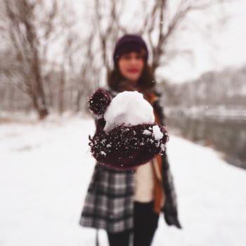 Woman outside holding snowball to symbolize snowball effect